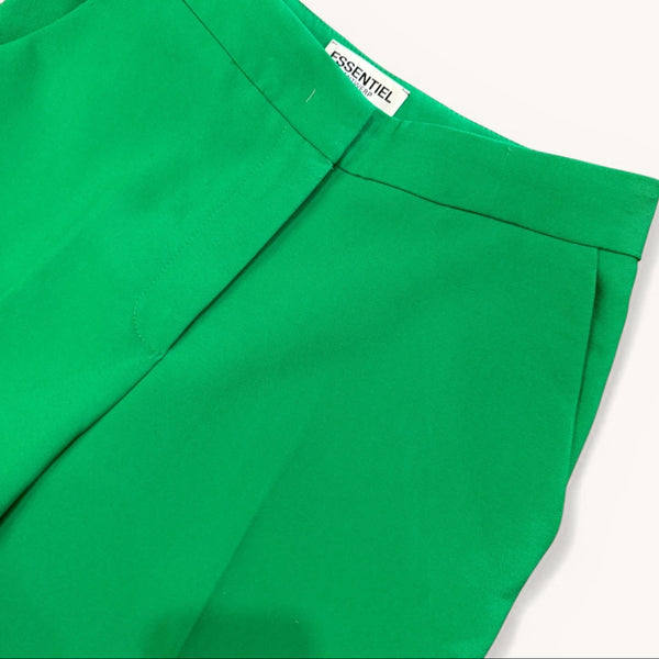 Green pants with a brand label on a white background