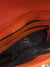 DKNY printed leather orange handbag/clutch